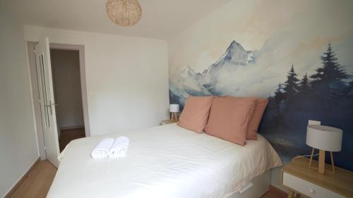 a bedroom with a bed with two slippers on it at Pyrénées Addict, appartement full equipped in Orthez