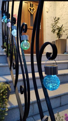 a row of glass lights on a wrought iron fence at Apartment Anna - Austrian country house in Marchfeld im Weinviertel in Marchegg