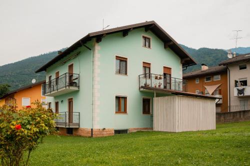 a green and white building with balconies on it at Lake View Levico in Levico Terme