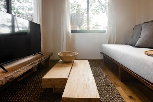 a room with a bed and a wooden coffee table at Dos Mares Venao Village in Playa Venao