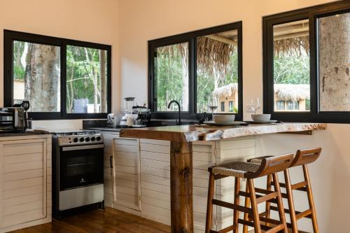 a kitchen with a counter and some windows at Dos Mares Venao Village in Playa Venao