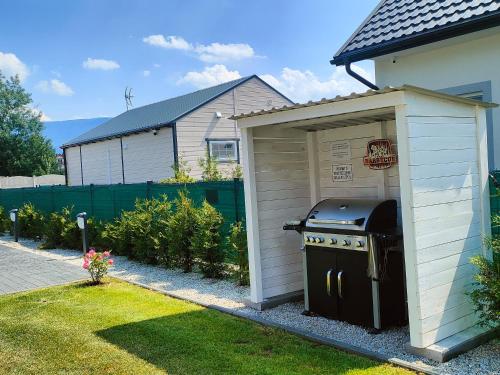 a barbecue shed in front of a house at Karkonoskie Zacisze pod Śnieżką in Miłków