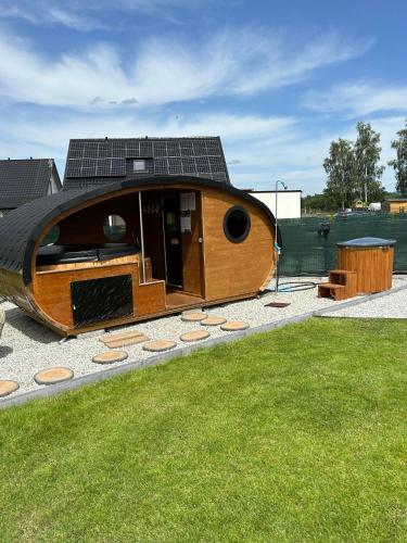 a house with a solar roof on top of a yard at Karkonoskie Zacisze pod Śnieżką in Miłków