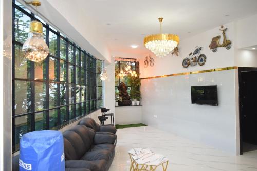 a living room with a couch and a fireplace at M Grand Stay in Coimbatore