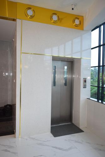a hallway with a elevator in a building at M Grand Stay in Coimbatore