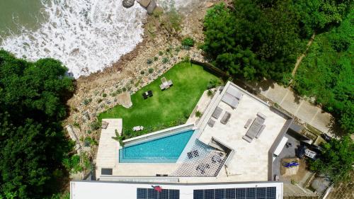 an aerial view of a house next to the ocean at The Flamingo Experience in San Juan del Sur