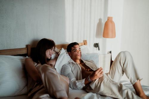 a man and a woman laying in bed at Kalani Residence in Keramotí