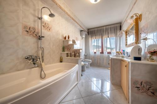 a bathroom with a tub and a sink and a toilet at Dolfi Grand Loft in Iglesias