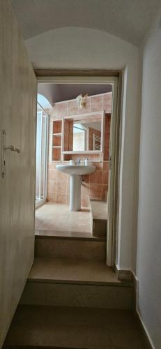 a bathroom with a sink and a mirror at Il vicoletto in Canosa di Puglia