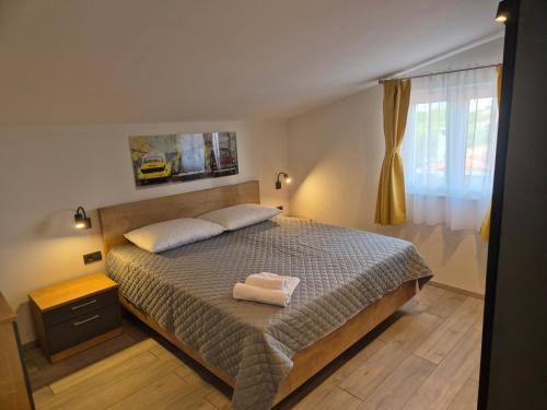 a bedroom with a bed with two towels on it at Apartment Donata in Privlaka