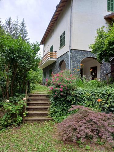 a building with stairs and flowers in front of it at La casa di nonna Angela in Sassello