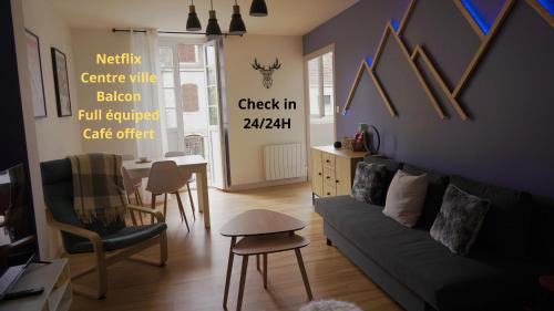 a living room with a couch and chairs and a table at Pyrénées Addict, appartement full equipped in Orthez