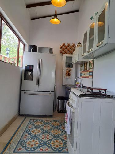 a kitchen with a refrigerator and a stove at Mirador De Las Pirámides in Zetaquira