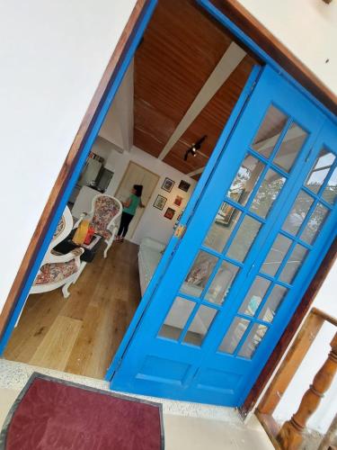 a blue door opens into a living room at Mirador De Las Pirámides in Zetaquira