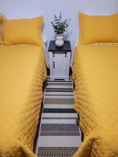 two beds in a room with a table between them at Brooklyn Luxury Suite in Brooklyn