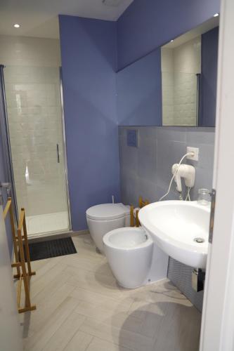 a bathroom with a white sink and a toilet at La Cicala in Brolo