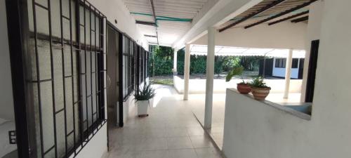 an empty hallway of a building with potted plants at HOTEL POSADA CAMPESTRE SAN JUAN in Monterrey