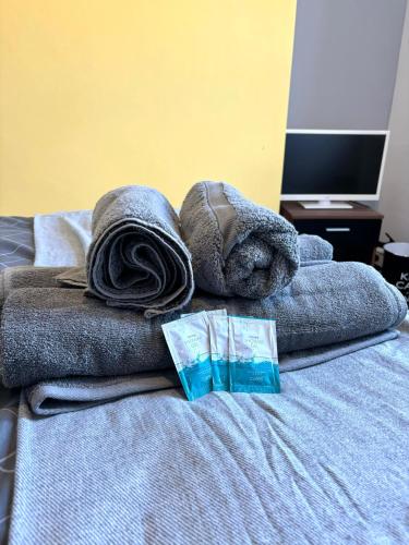 a pile of towels sitting on top of a bed at CROFT House in Manchester