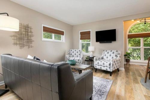 a living room with a couch and two chairs at 2min walk downtown-Pet Friendly-Offstreet Parking in Saugatuck