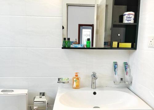 a bathroom with a sink and a mirror and a toothbrush at Beach Front Easy Living in Karagampitiya