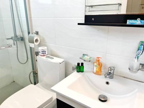 a bathroom with a sink and a toilet and a shower at Beach Front Easy Living in Karagampitiya