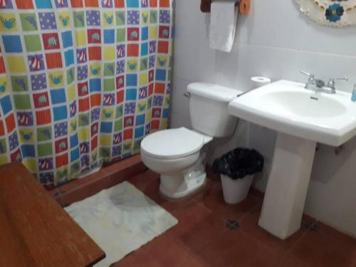 a bathroom with a toilet and a sink at Villa La Giralda - Lakefront - Pool - View - Relaxation Haven in Masaya