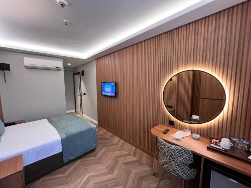 a hotel room with a bed and a mirror at Gumus Palace Hotel in Istanbul