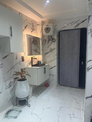 a bathroom with a sink and a mirror at Blessedlife Apartment in Kumasi