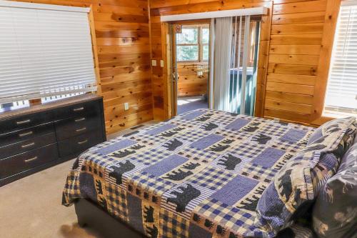 a bedroom with a bed in a wooden cabin at Hibernation Haven in McHenry