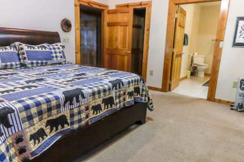 a bedroom with a bed with a blue and white blanket at Hibernation Haven in McHenry