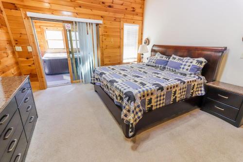 a bedroom with a bed and a bathroom in a cabin at Hibernation Haven in McHenry