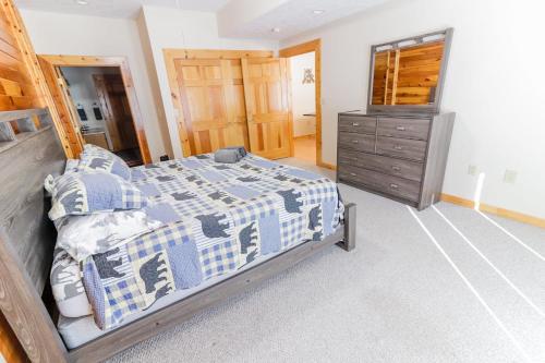 a bedroom with a bed and a dresser in it at Hibernation Haven in McHenry