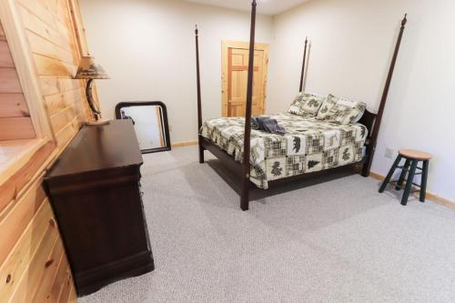 a bedroom with a bed and a mirror and a table at Hibernation Haven in McHenry