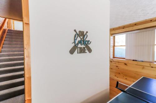 a staircase in a house with a sign on the wall at Hibernation Haven in McHenry