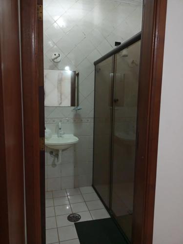 a bathroom with a shower and a sink at Recanto Praia Peruibe in Peruíbe