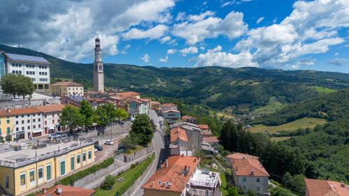 a town in the mountains with a clock tower at diana rooms in Lusiana