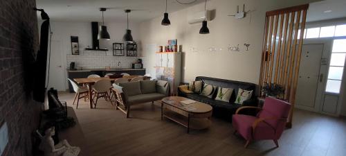 a living room with a table and a couch and chairs at AniCa II, el lugar de la Mancha in Argamasilla de Alba
