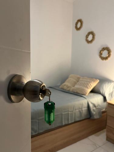 a bedroom with a bed with a green lantern on it at Pensiòn Cerdà 112 in Alicante