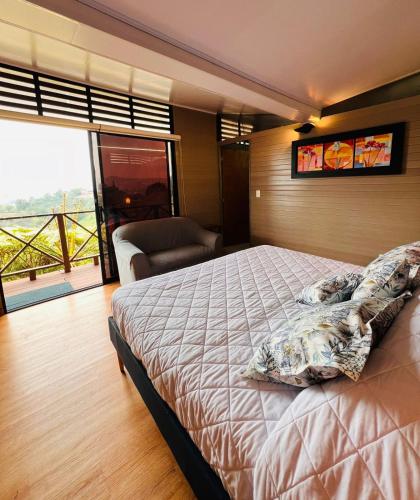 a bedroom with a large bed and a large window at Eco Lodge Glamping in Guatapé