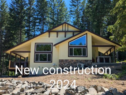 a house with a new construction sign in front of it at Bird House in Packwood