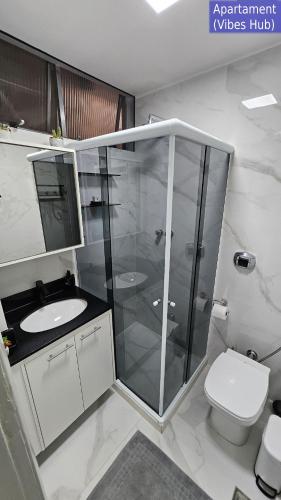 a bathroom with a glass shower and a toilet at Copacabana Vibes Studios in Rio de Janeiro