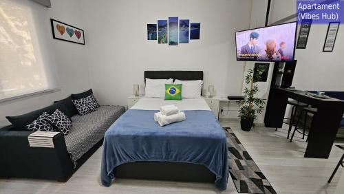 a room with a bed and a couch and a tv at Copacabana Vibes Studios in Rio de Janeiro