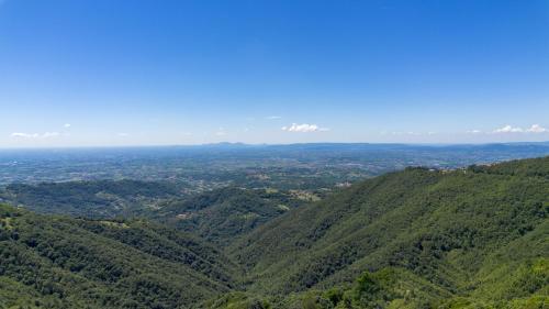 an aerial view of a forested mountain range at diana rooms in Lusiana