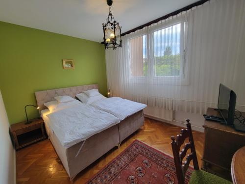a bedroom with a bed and a television in it at Belvárosi Classic Apartman 85 square meters in Szombathely