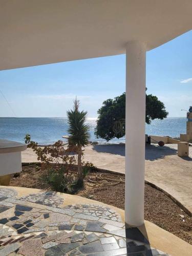 a view of the ocean from a patio with a table at maison plage kerkennah in Mouamla