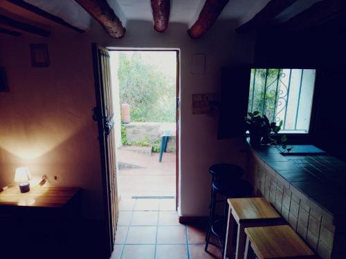 a hallway with a door leading to a patio at Cortijo Rural Violeta in Órgiva