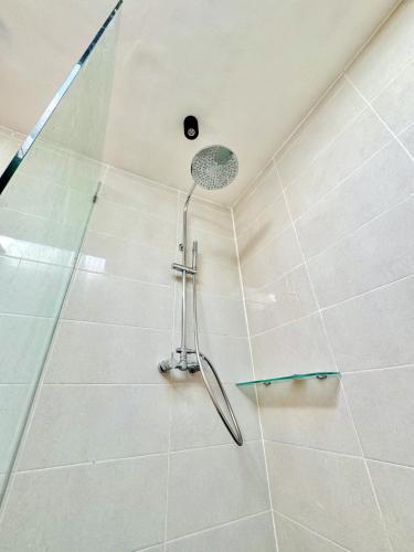a shower with a glass door in a bathroom at Bali Shanti Villa in Uluwatu
