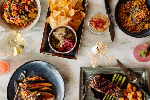 a table topped with plates of food and bowls of food at Sheraton Phoenix Downtown in Phoenix