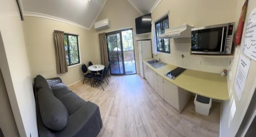 a living room with a couch and a table at 1770 Holiday Village in Seventeen Seventy