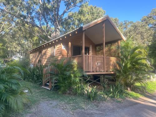 a log cabin with a porch and a balcony at 1770 Holiday Village in Seventeen Seventy